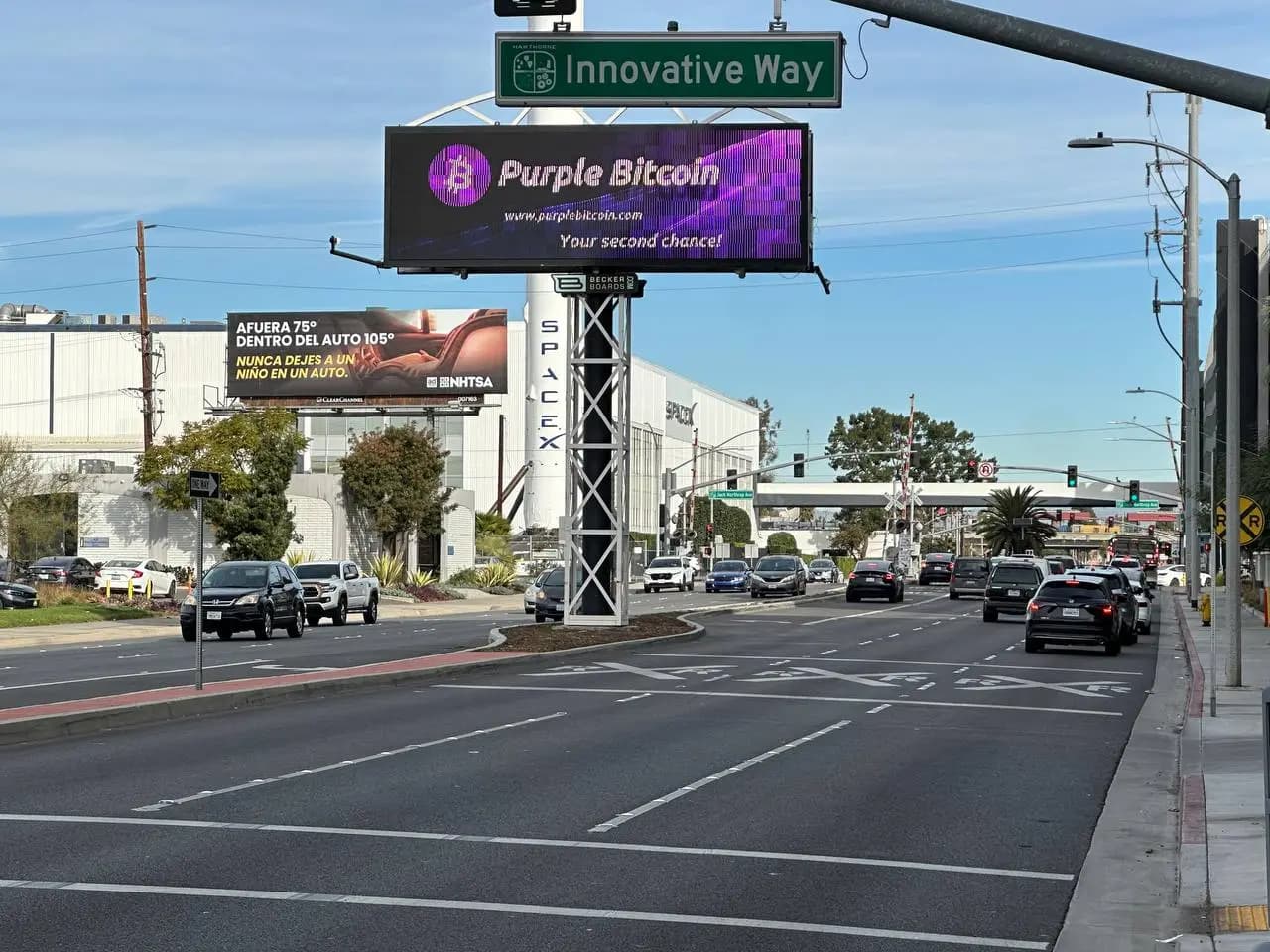 Purple Bitcoin billboard in a high-traffic US location